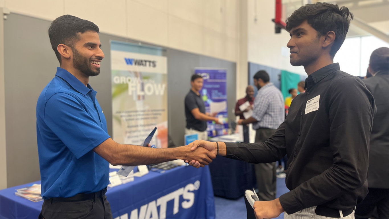 Watts Interns shaking hands.